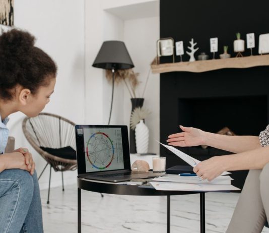 5 Zodiac Signs That Naturally Attract Love and Romance Two women discussing an astrology birth chart on a laptop