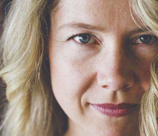 What Your Eyes Reveal According to Your Zodiac Sign Close portrait of a woman with a calm direct gaze